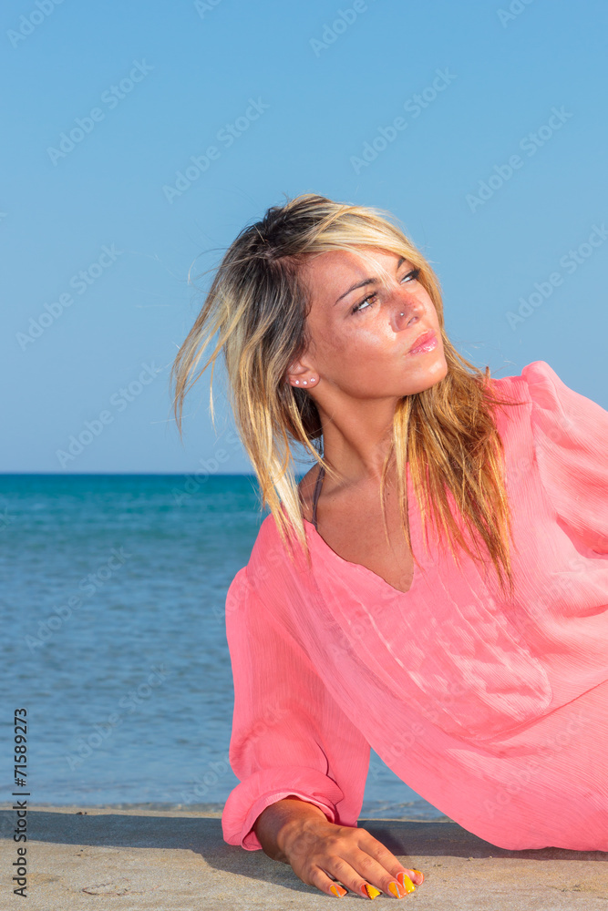 Girl on beach wearing pink top Girl on beach wearing pink top