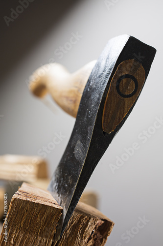 Old wooden handle axe in a block of wood