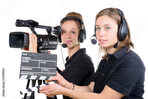 two pretty young women work with a video camera photo