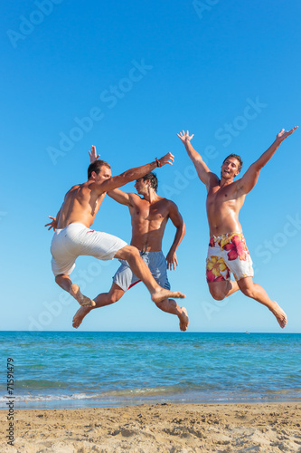 Three young men on the beach