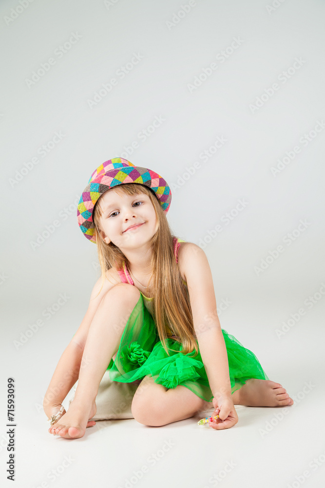Little fashion girl in beautiful dress posing
