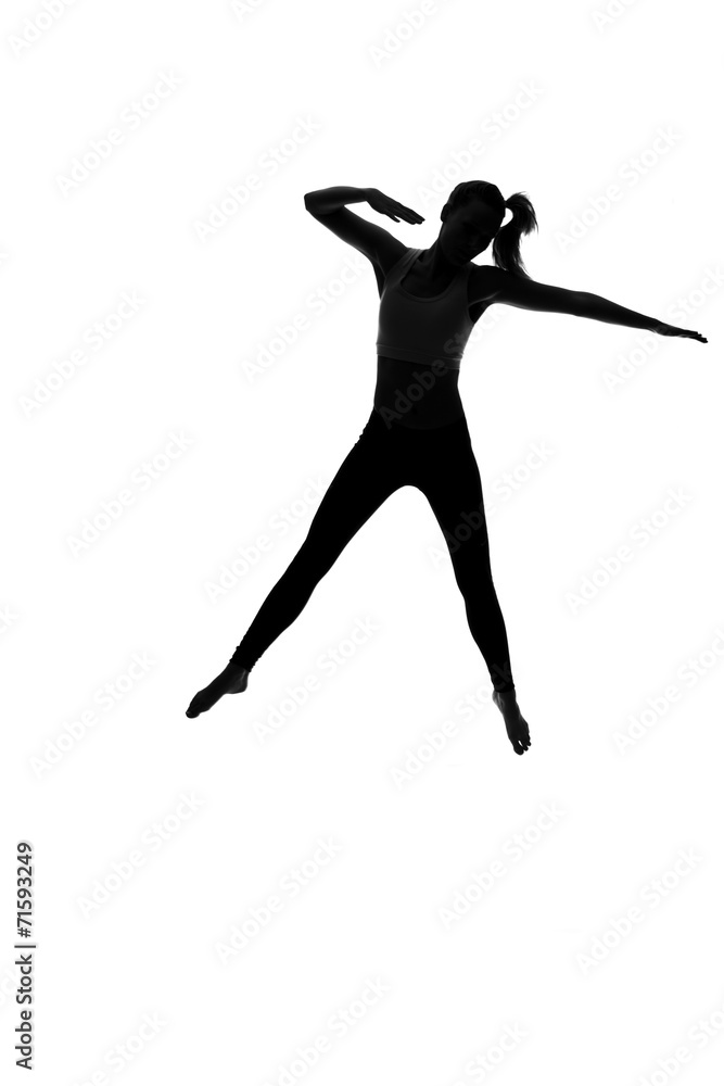Silhouette of young woman dancing against white background