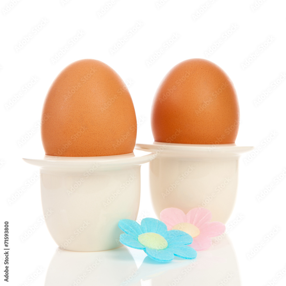 Two chicken eggs in holder with flowers Two chicken eggs in holder with flowers