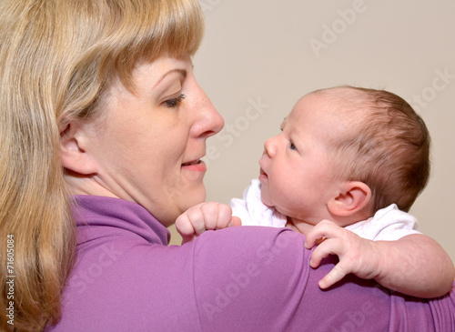 Portrait of the young woman with the baby on hands