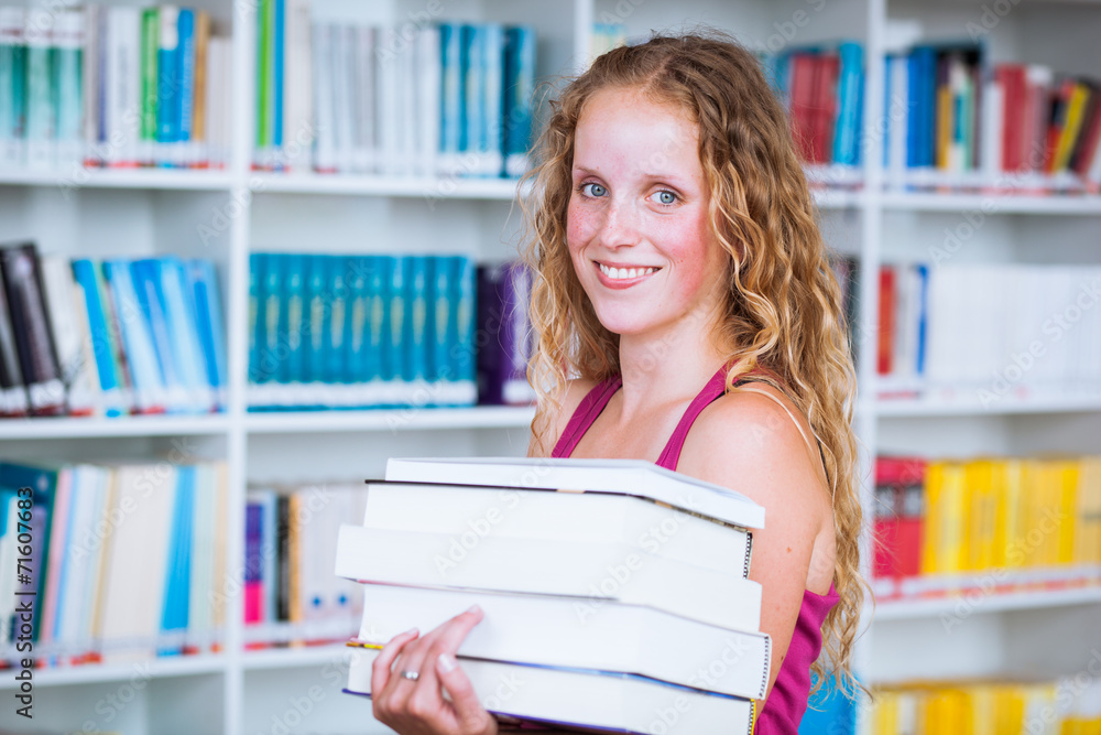 Pretty, young female college student in a library Pretty, young female college student in a library