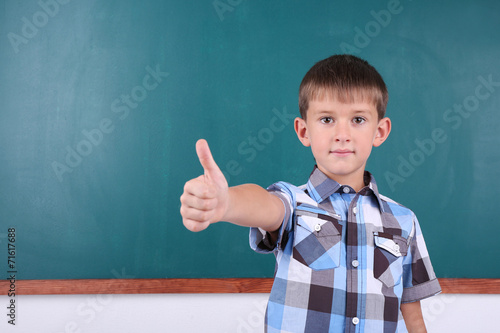 Schoolboy at blackboard in ...