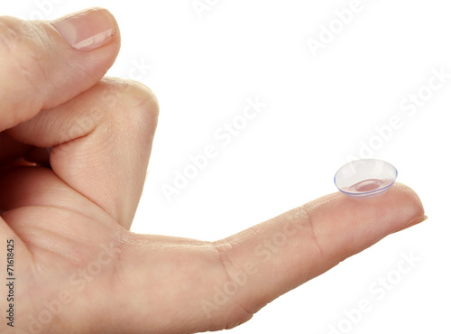 Contact lens on finger isolated on white