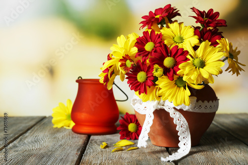 Fototapeta Naklejka Na Ścianę i Meble -  Beautiful chrysanthemum in pot with candlestick