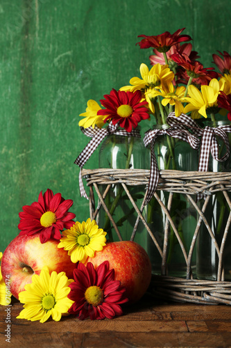 Beautiful chrysanthemum in vases with apples