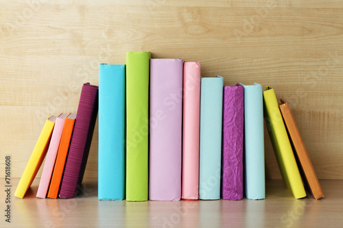 Books on wooden shelf close-up