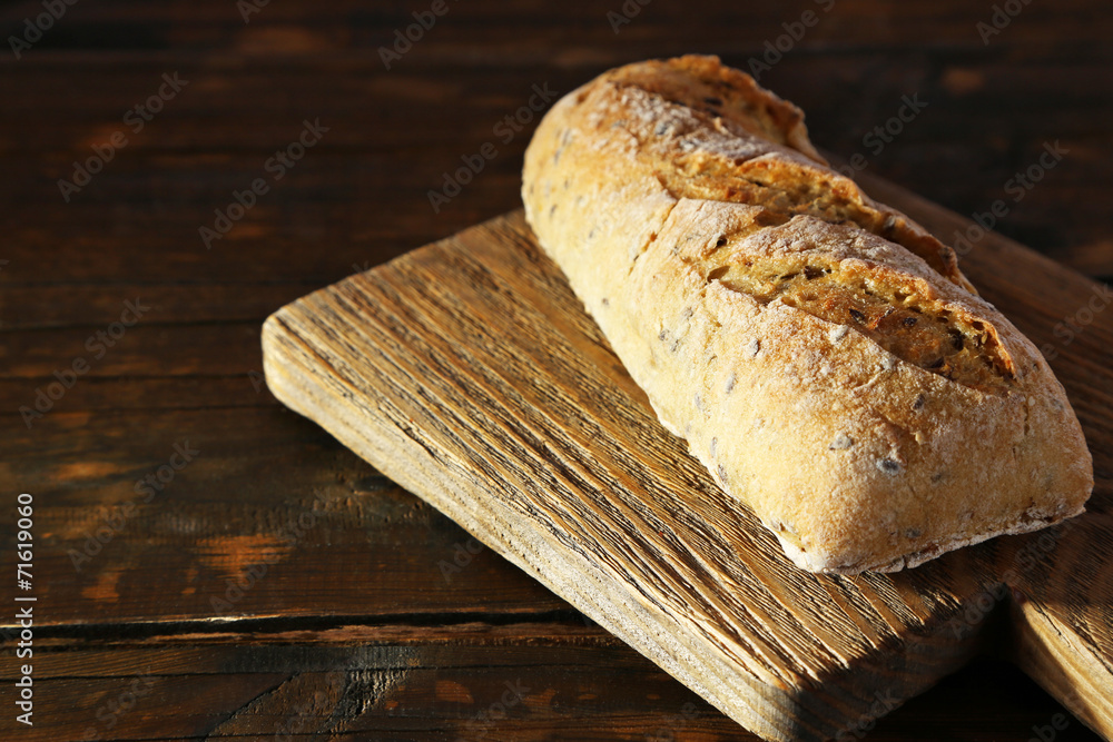 White bread on cutting board on wooden background