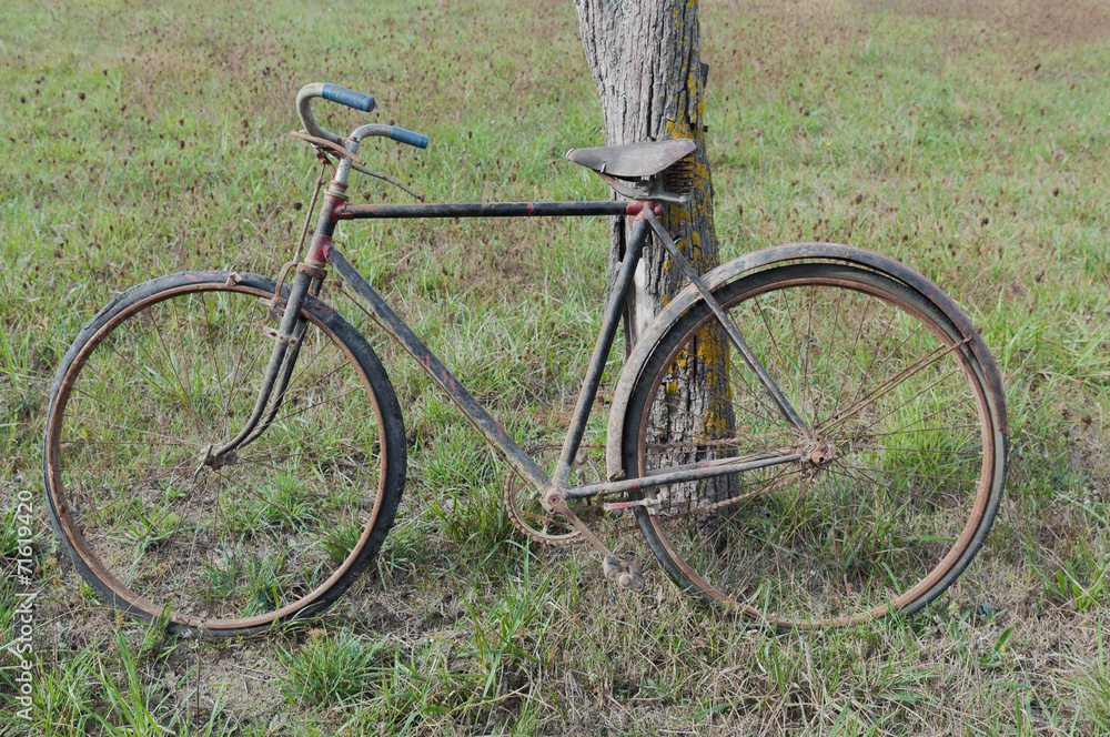 Antique or retro oxidized bicycle outside