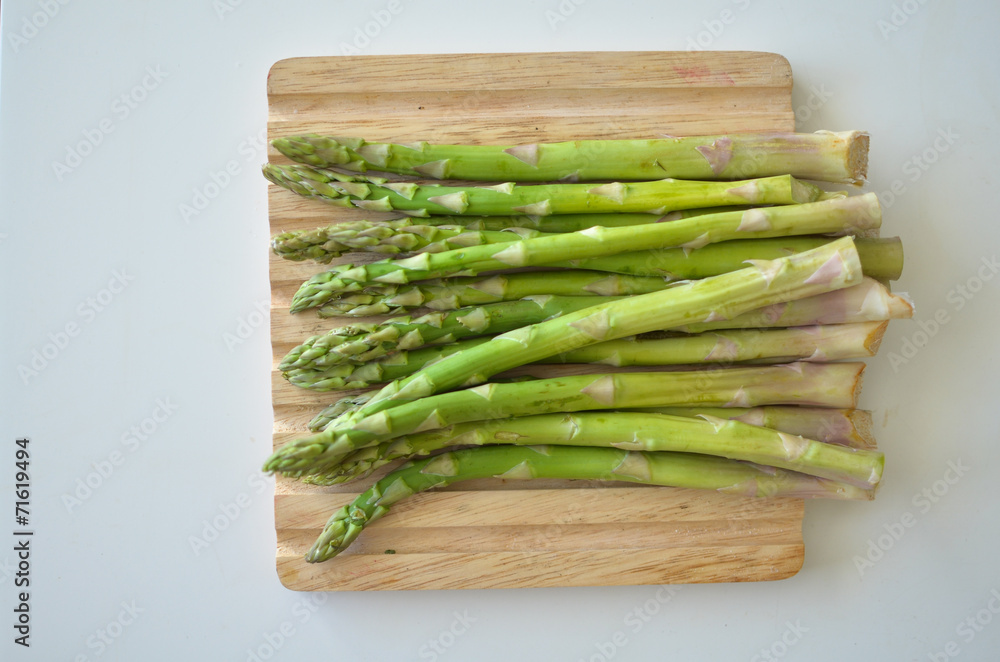 Bunch of fresh green asparagus spears on a rustic wooden table Bunch of fresh green asparagus spears on a rustic wooden table
