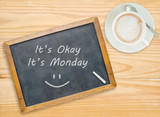 It's Okay ,It's Monday on chalkboard with coffee cup