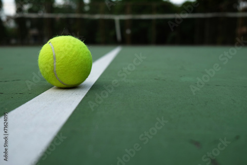 tennis ball on court © winnievinzence