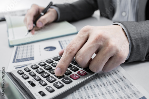 Businessman analyzing investment charts with laptop. Accounting