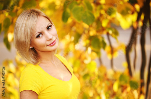Autumn Woman. Blonde Girl and Yellow Leaves. Portrait. Fall