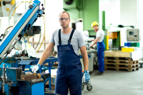 worker with goggles on the machine