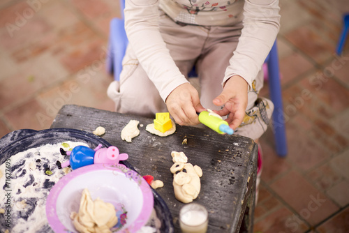 child's hands playing with dough photo