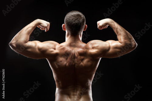 Man back shows big muscles.