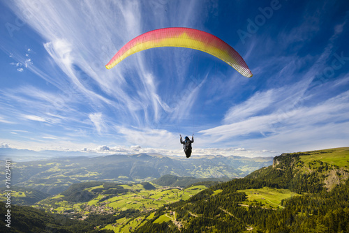 Paraglider flying over mountains photo
