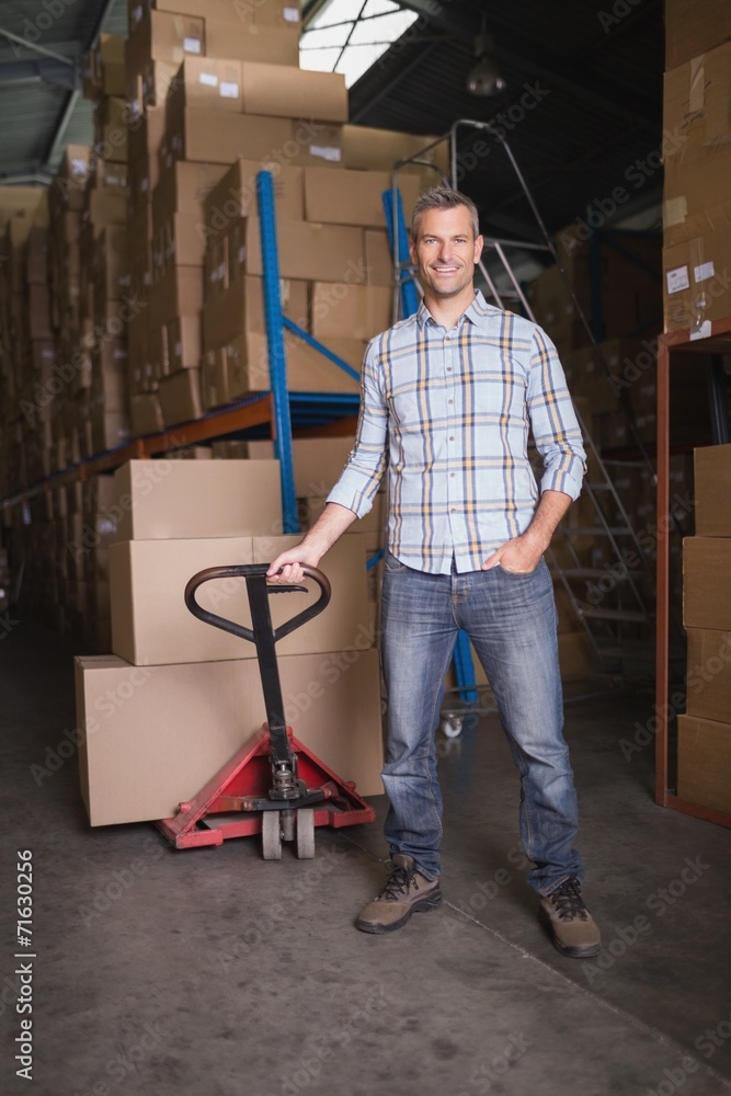 Worker with trolley of boxes in warehouse Worker with trolley of boxes in warehouse