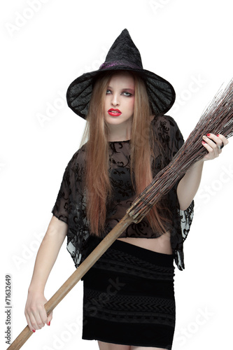 Young girl in witch costume with a broom © master1305