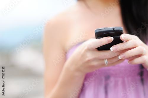 A young girl is gaining on the cell phone.