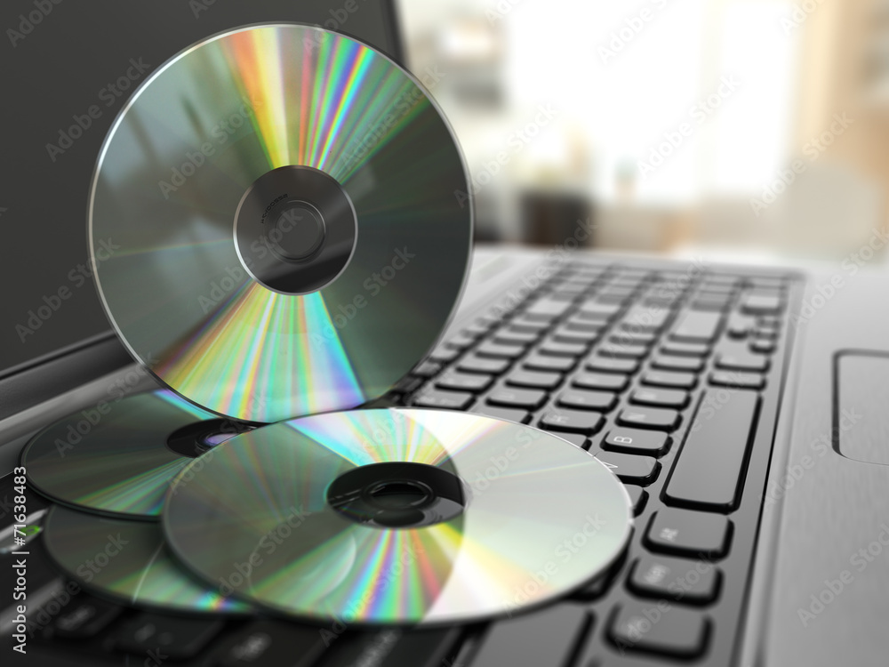 Software CD on laptop keyboard. Compact disks. Software CD on laptop keyboard. Compact disks.
