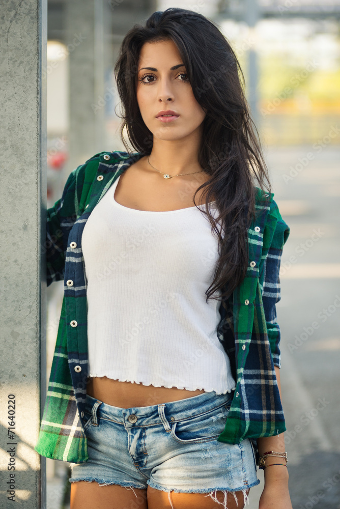 Beautiful young woman portrait outdoors in a parking.