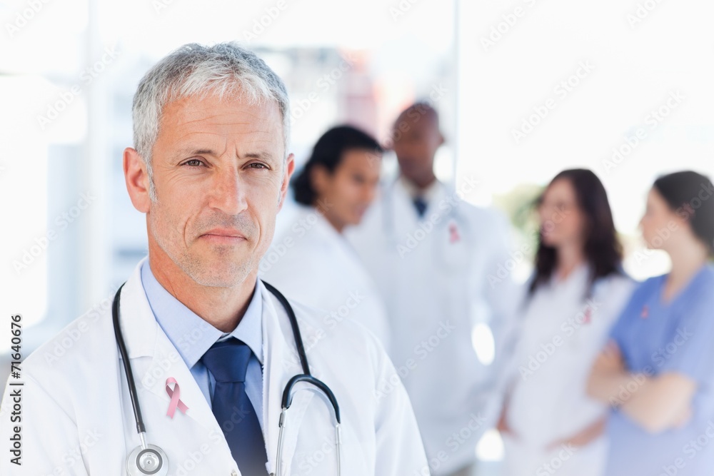 Composite image of mature doctor looking straight ahead Composite image of mature doctor looking straight ahead