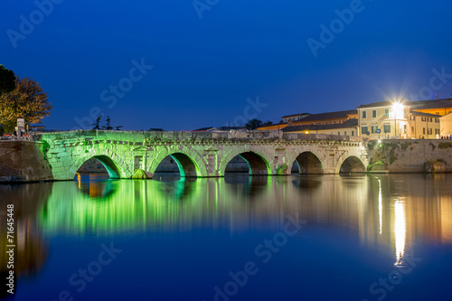 Rimini. Twilight on historical Tiberius bridge. photo