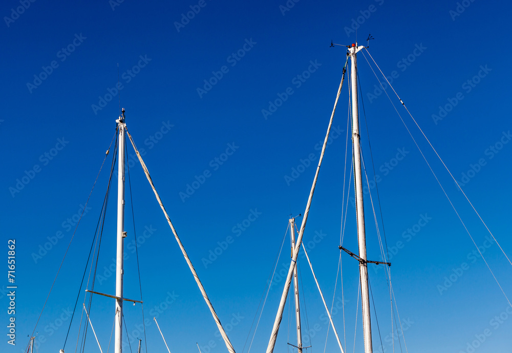 Detail shot of sailing boat poles (mainmasts) in marina. Detail shot of sailing boat poles (mainmasts) in marina.