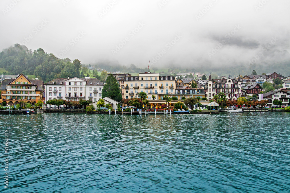 Swiss town on Lucerne lake in fog, Switzerland