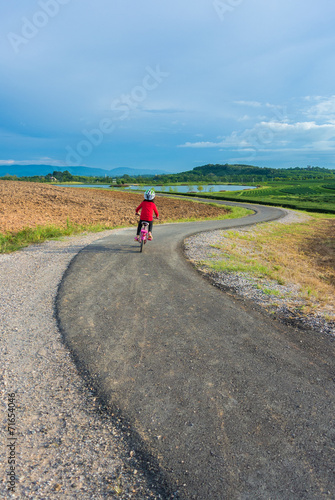 kid ride bicycle on the way