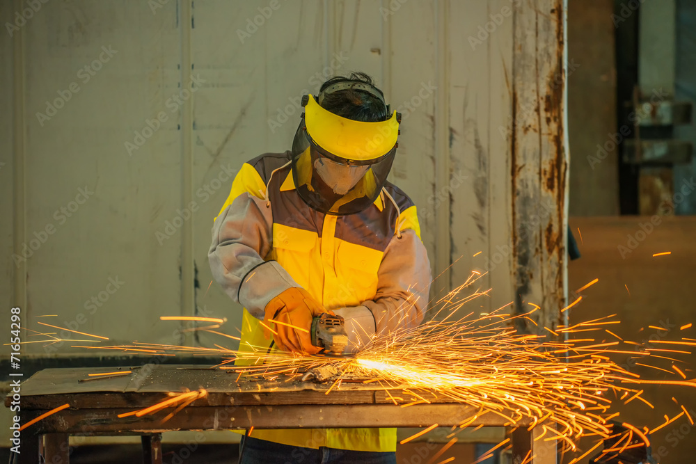 Manual worker work in factory with grinder Manual worker work in factory with grinder