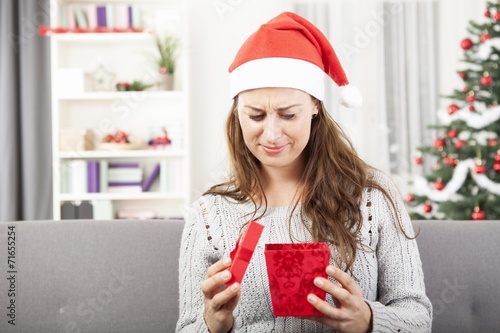 young girl is sad about christmas gift