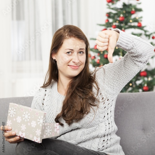 girl is unhappy about christmas gift and thumb down
