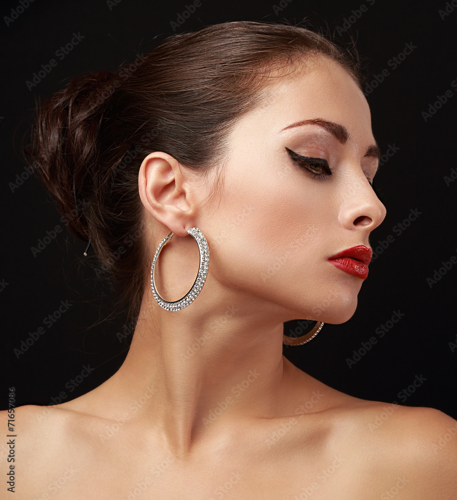 Foto de Beautiful woman face profile in fashion earrings do Stock | Adobe  Stock