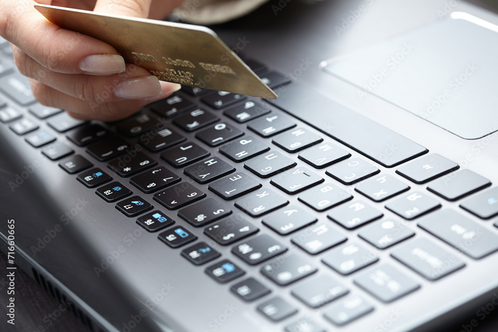 woman holding credit card on laptop for online shopping concep woman holding credit card on laptop for online shopping concep