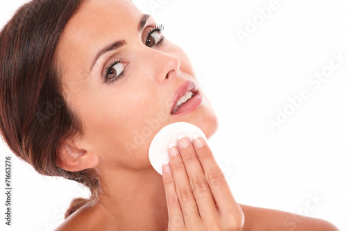 Sensual and pretty woman pampering her face