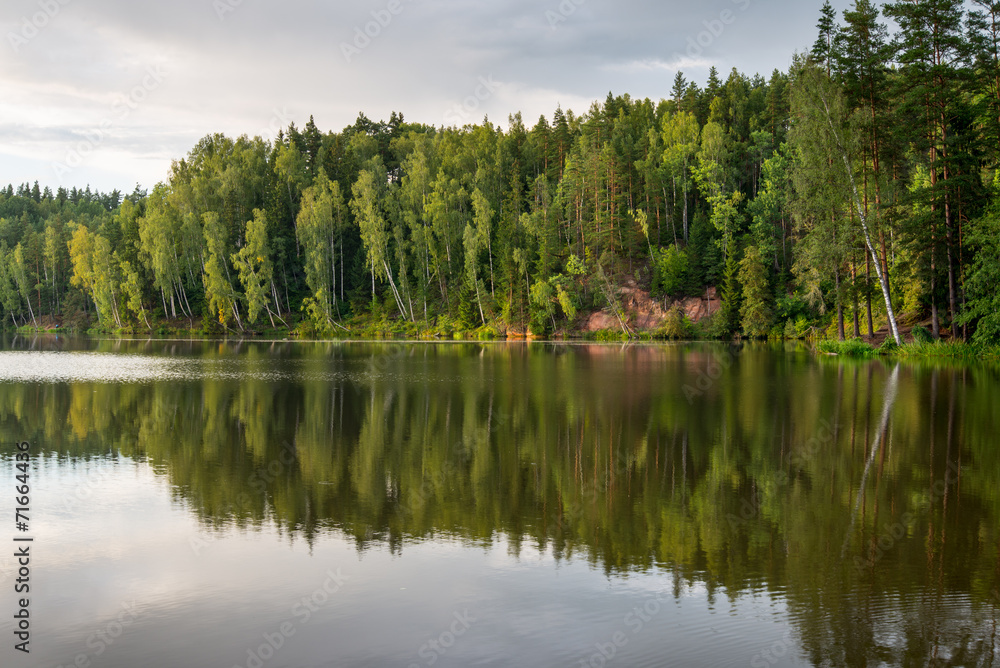 Fototapeta premium river with reflections in weater and sandstone cliffs