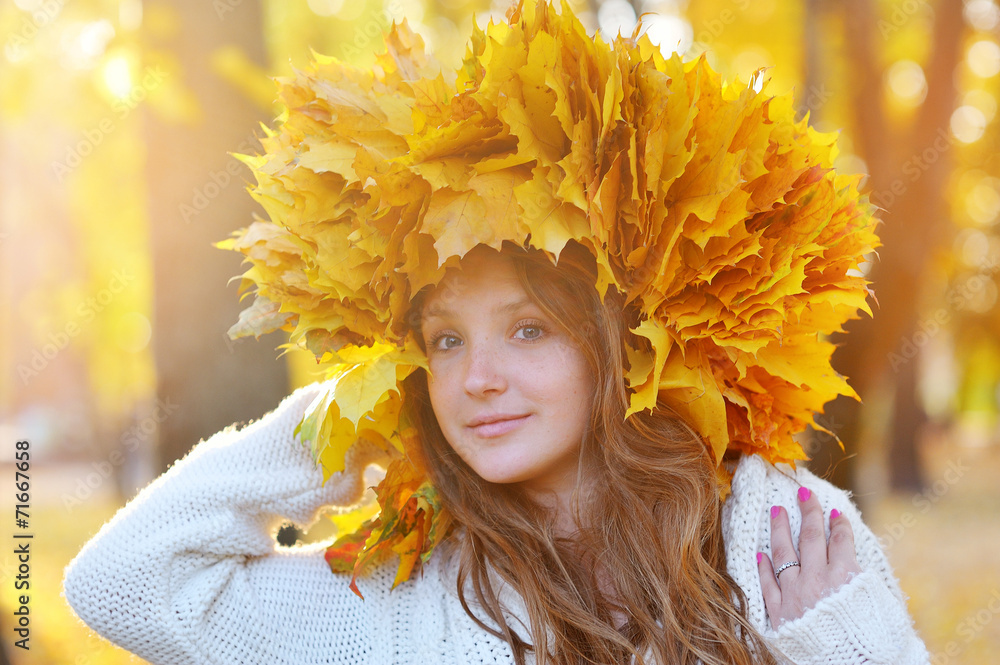 Young woman with autumn leaves in hand and fall yellow maple gar Young woman with autumn leaves in hand and fall yellow maple gar