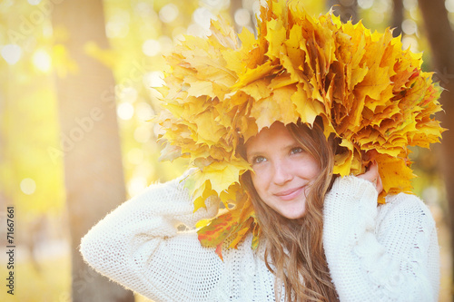 Young beautiful girl with autumn leaves in his hand, and the wre photo