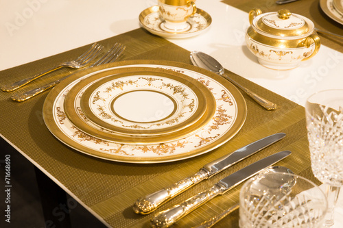Elegant gold and white china plates in setting
