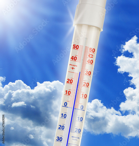 Alcohol thermometer over blue sky