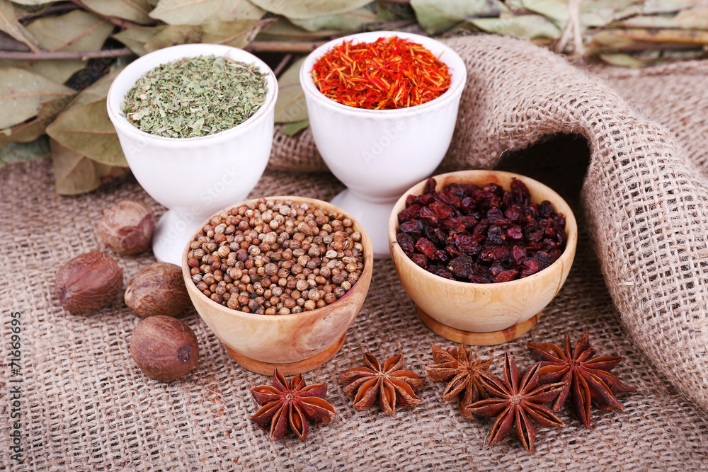 Small round tea and wooden bowls with different seasoning and Small round tea and wooden bowls with different seasoning and