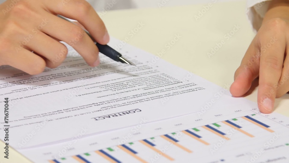 Business worker signing the contract to conclude a deal Business worker signing the contract to conclude a deal