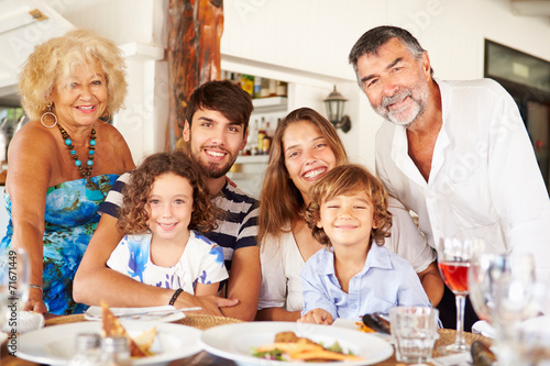 Multi Generation Family Enjoying Meal In Restaurant