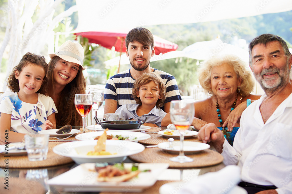 Multi Generation Family Enjoying Meal In Restaurant Multi Generation Family Enjoying Meal In Restaurant